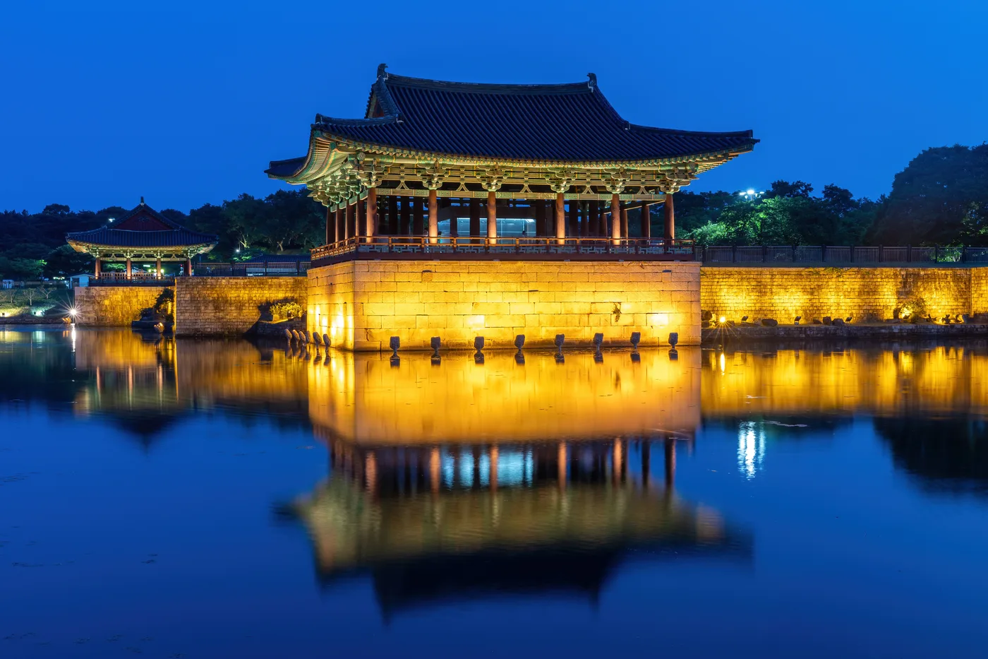 Donggung Palace pavilion illuminated at night and reflected in the still water of Wolji Pond in Gyeongju