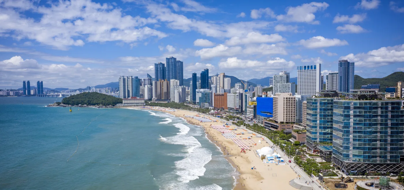 Aerial view of Haeundae Beach in Busan lined with high-rise buildings along the sand