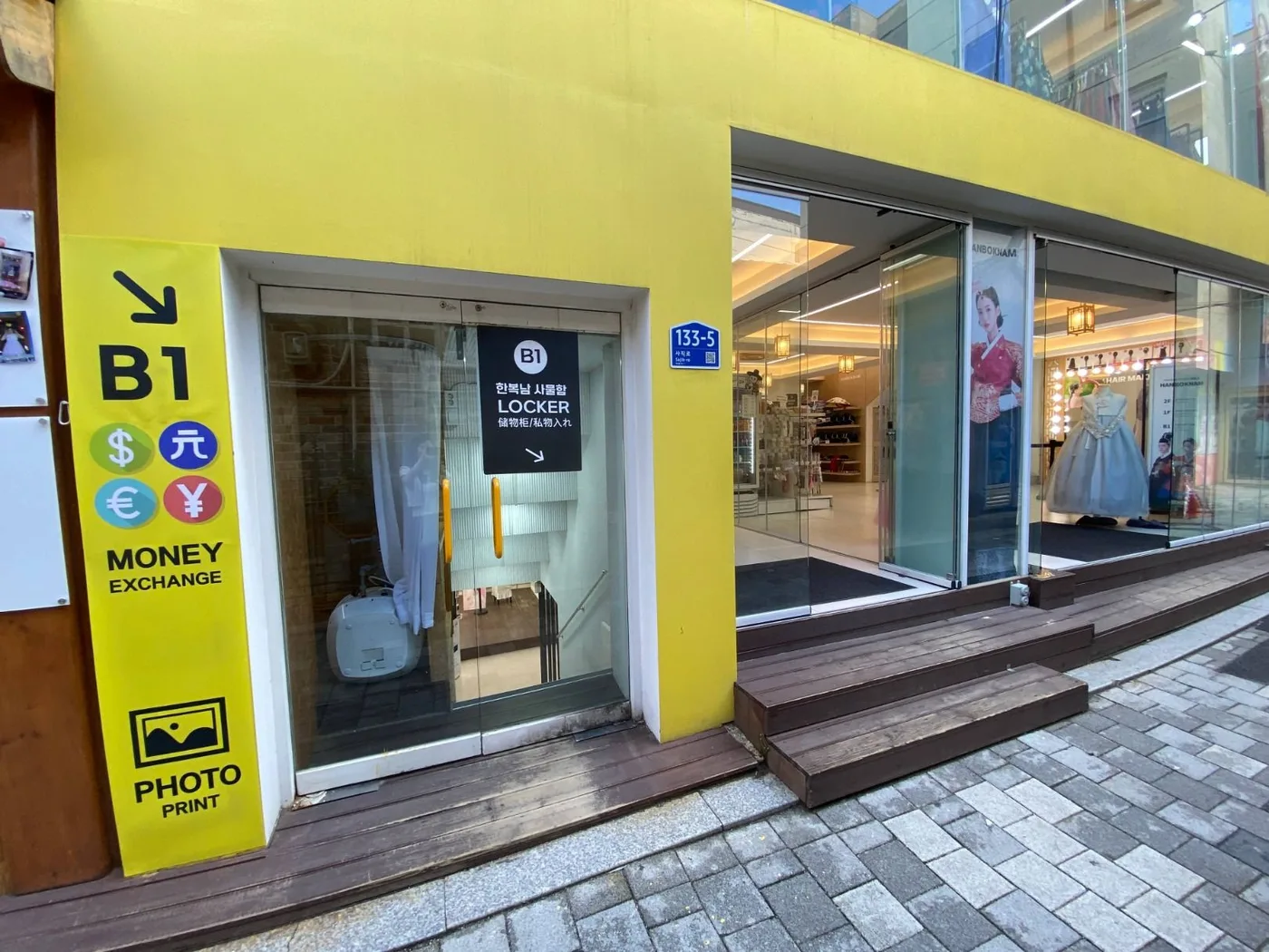 The storefront of Hanboknam, a hanbok rental shop near Gyeongbokgung Palace in Seoul, with hanbok displayed in the window