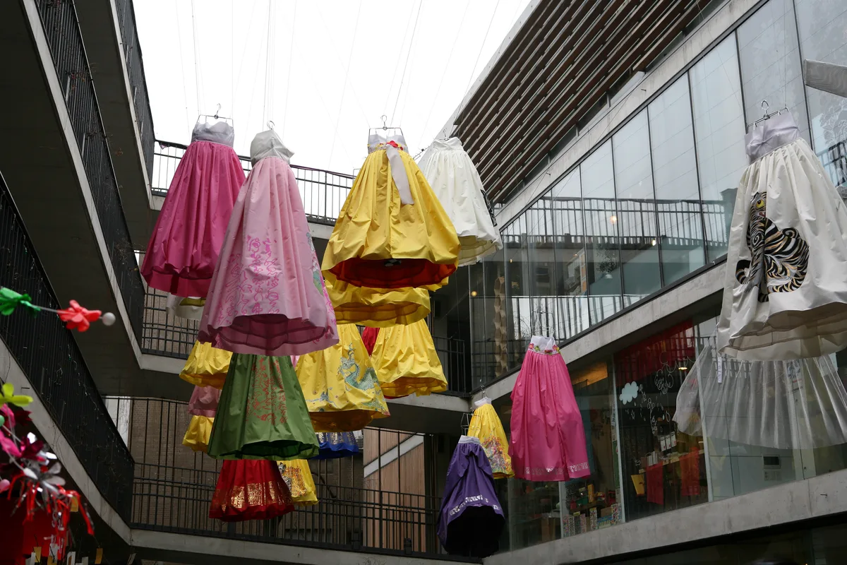 Colorful hanbok-style fabric hung as an art installation above a courtyard in Insadong, Seoul