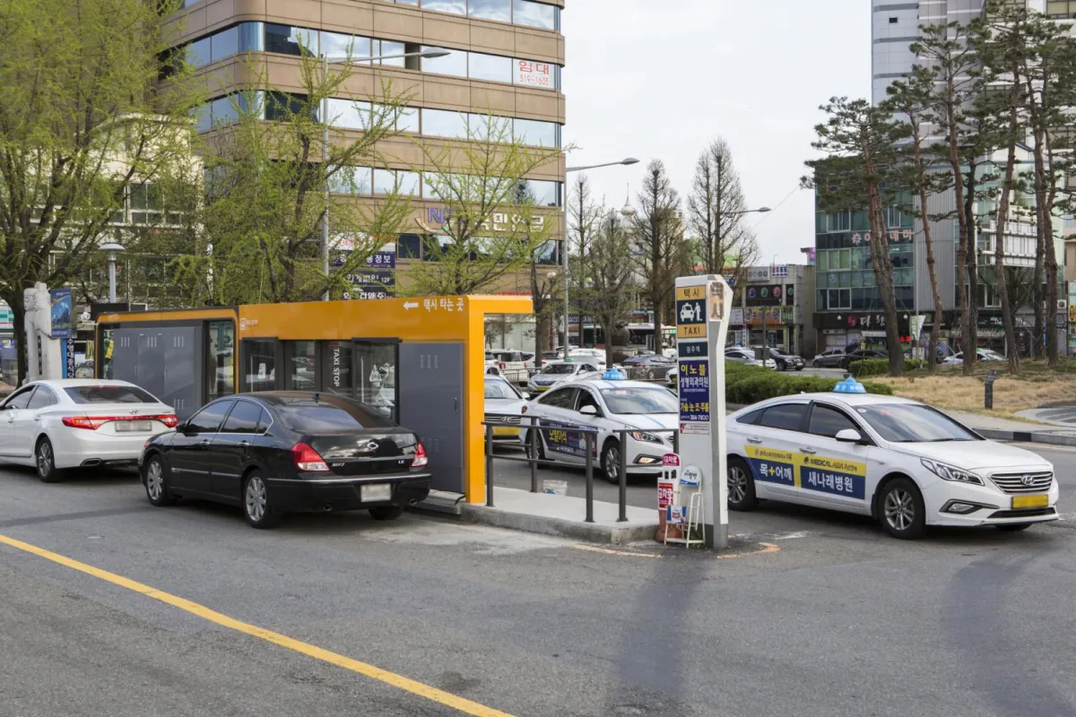 Standard taxis lined up at a marked taxi stand in Korea