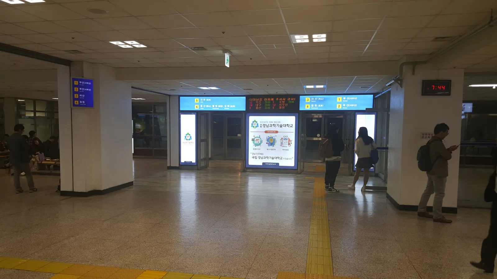 Departure gate signage at Seoul Express Bus Terminal listing destinations including Busan, Masan and Changwon