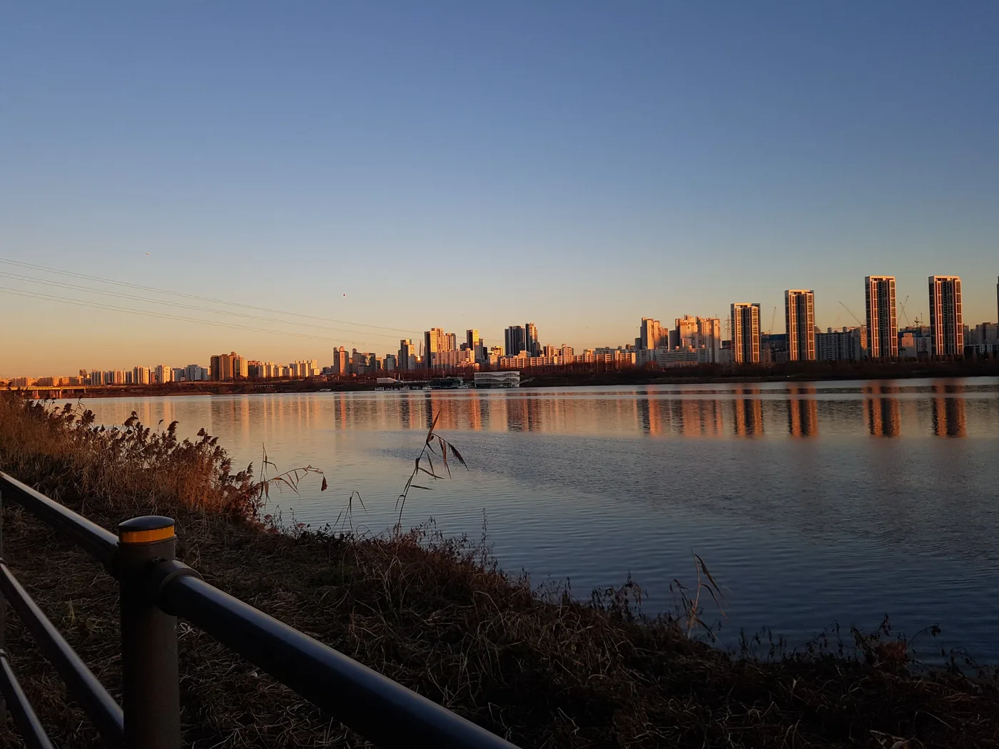 Seoul's skyline reflected in the Han River at sunset, seen from across the water