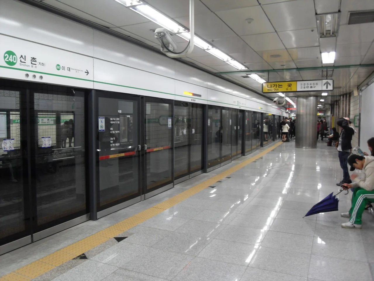Seoul subway Line 2 platform at Sinchon Station, with platform screen doors and Way Out signage